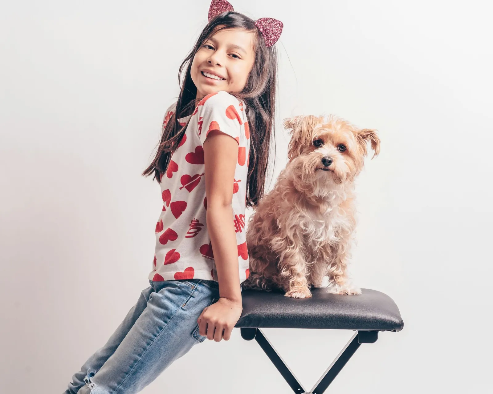 A smiling child with her dog